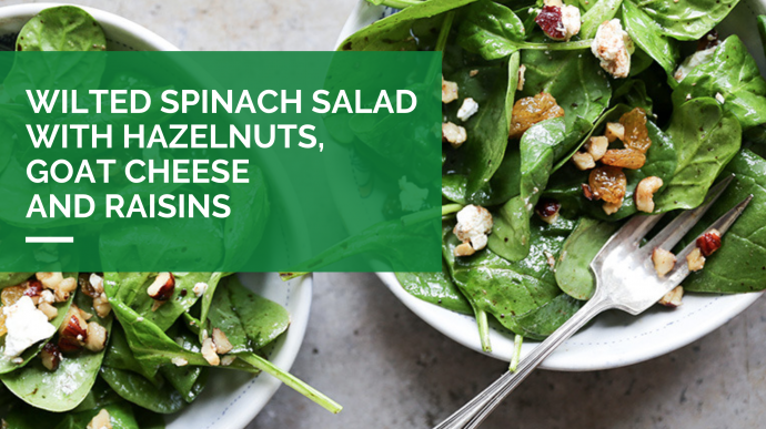Wilted Spinach Salad with Goat Cheese, Hazelnuts, and Raisins